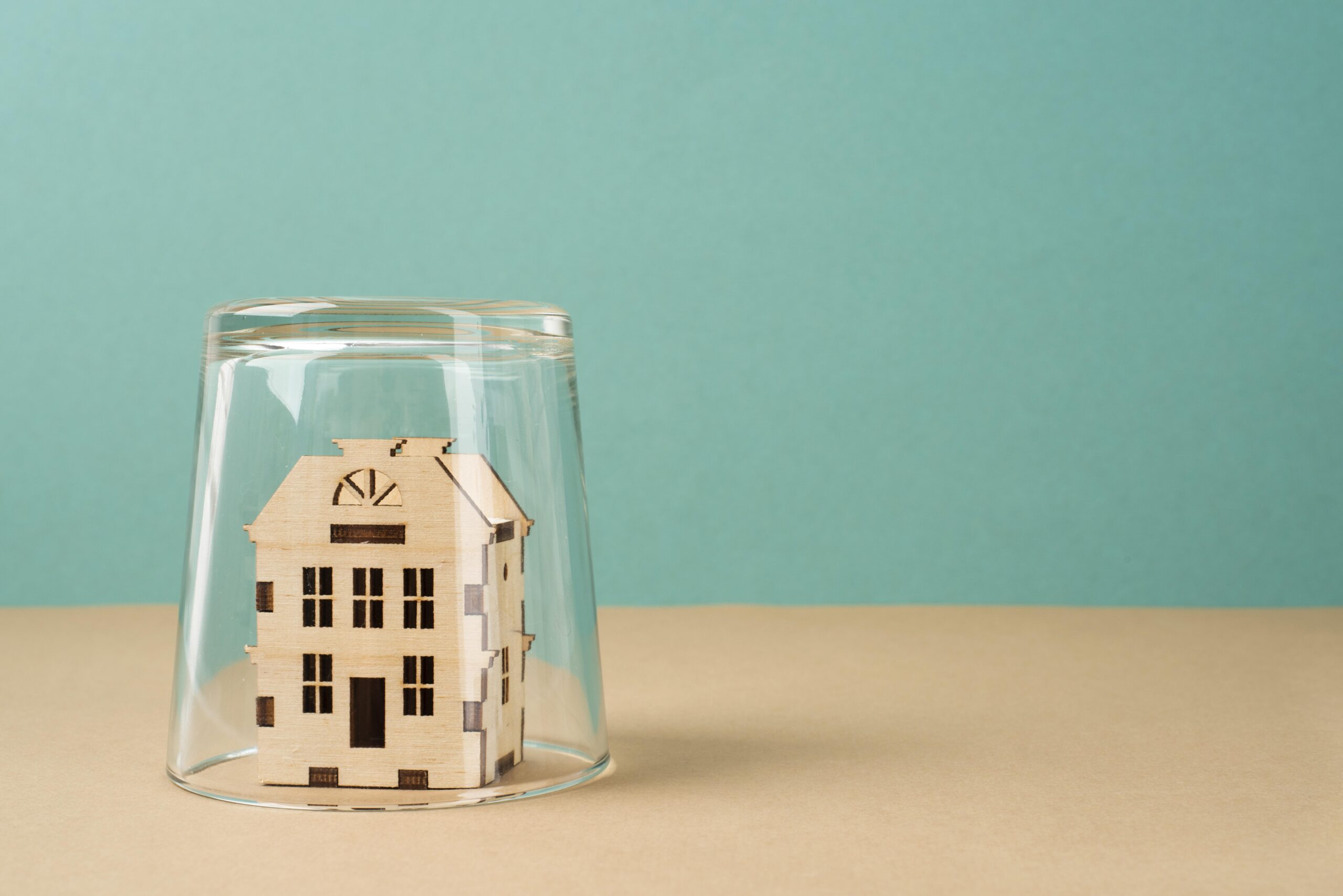 a house convered by a glass representing the safe guarding of an asset